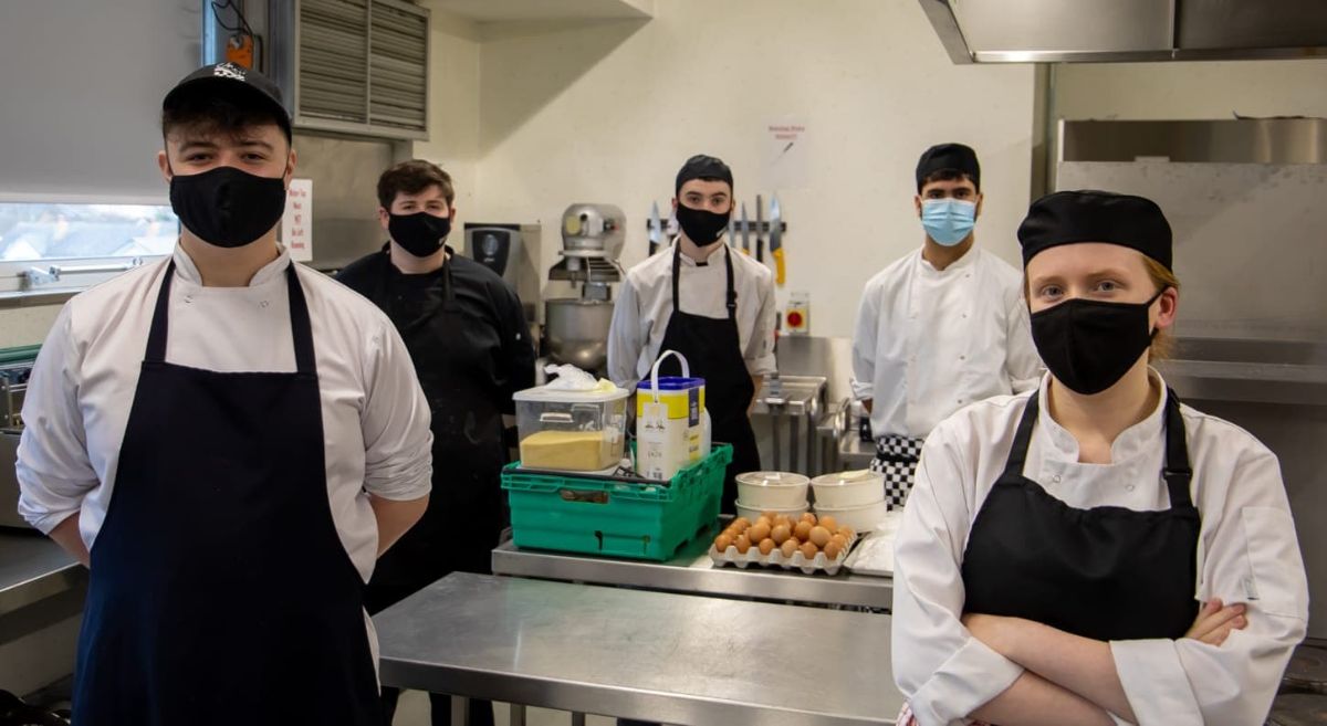 Five SERC students in catering whites pictured in training kitchen at Bangor Campus.